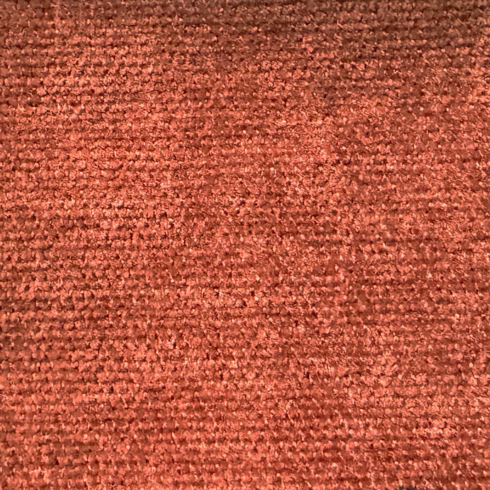 Rich terracotta chenille fabric texture with a soft plush pile for upholstery