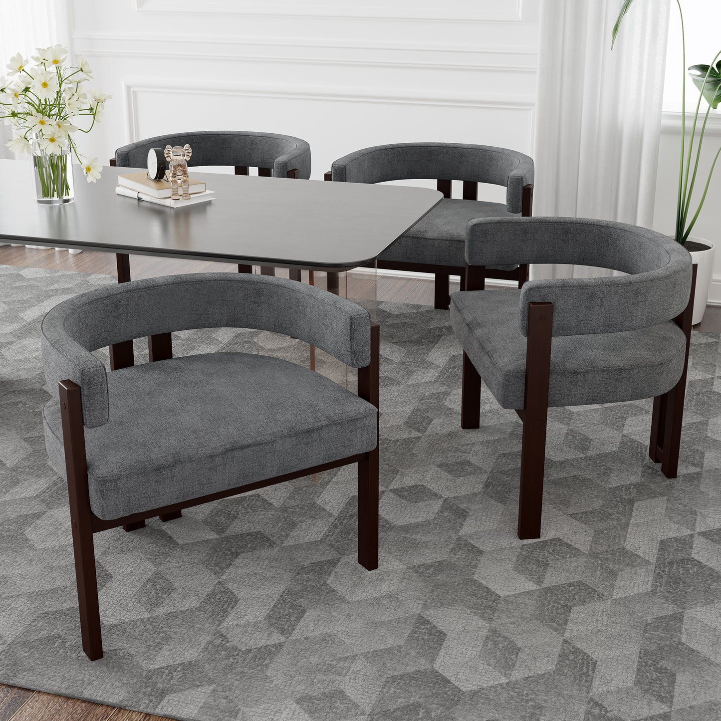 Four gray upholstered dining chairs with dark wood frames surround a modern dining table