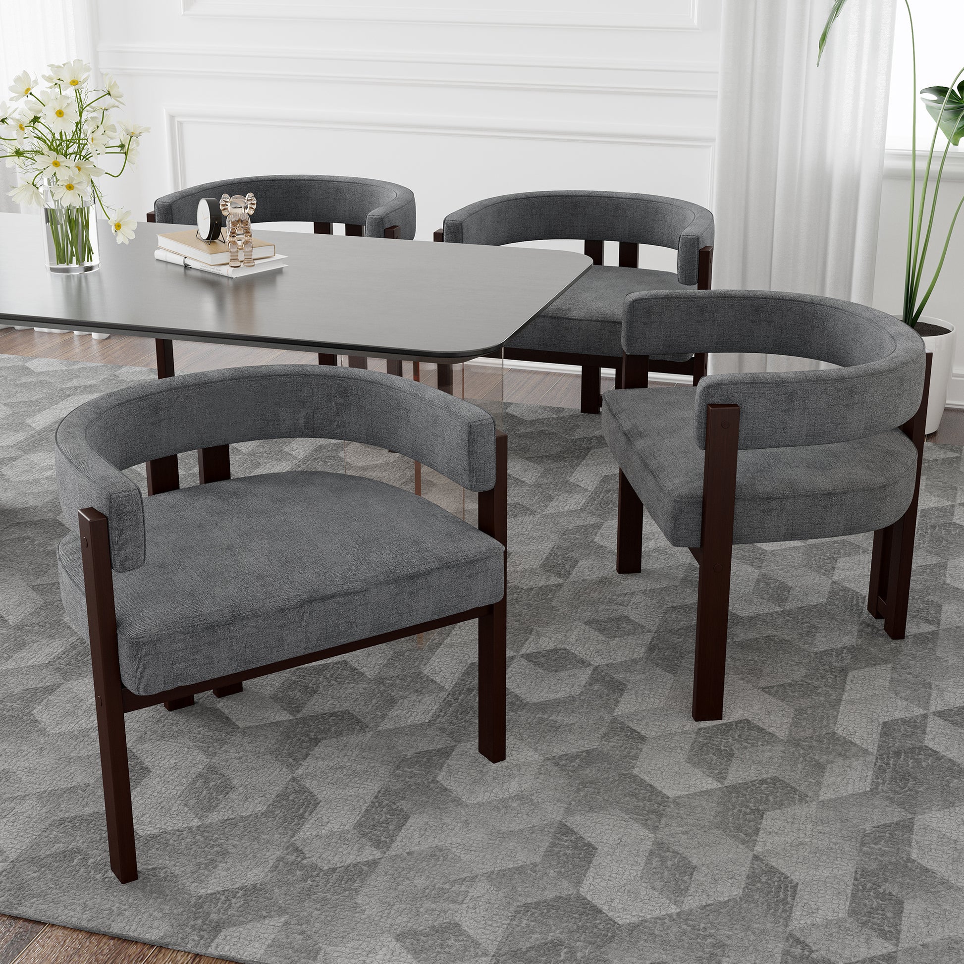 Four gray upholstered dining chairs with dark wood frames surround a modern dining table