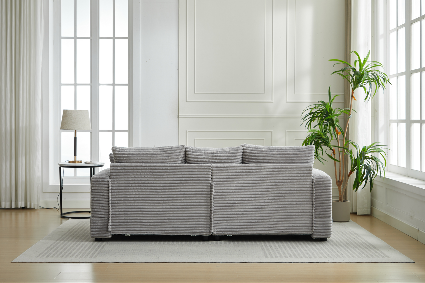 Plush grey corduroy sofa with three cushions and modern minimalist design