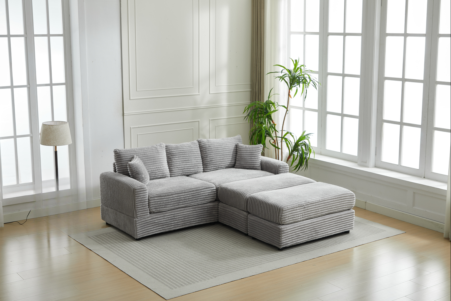 Plush corduroy sectional sofa in light grey with matching ottoman ideal for living rooms