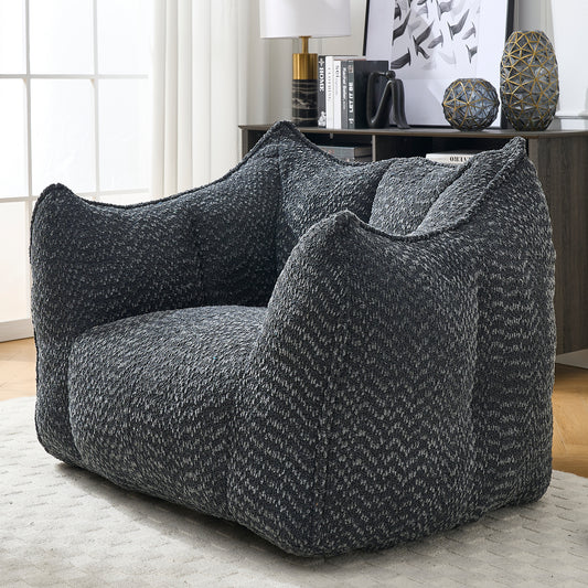 Dark gray textured bean bag chair with wide arms and plush seating