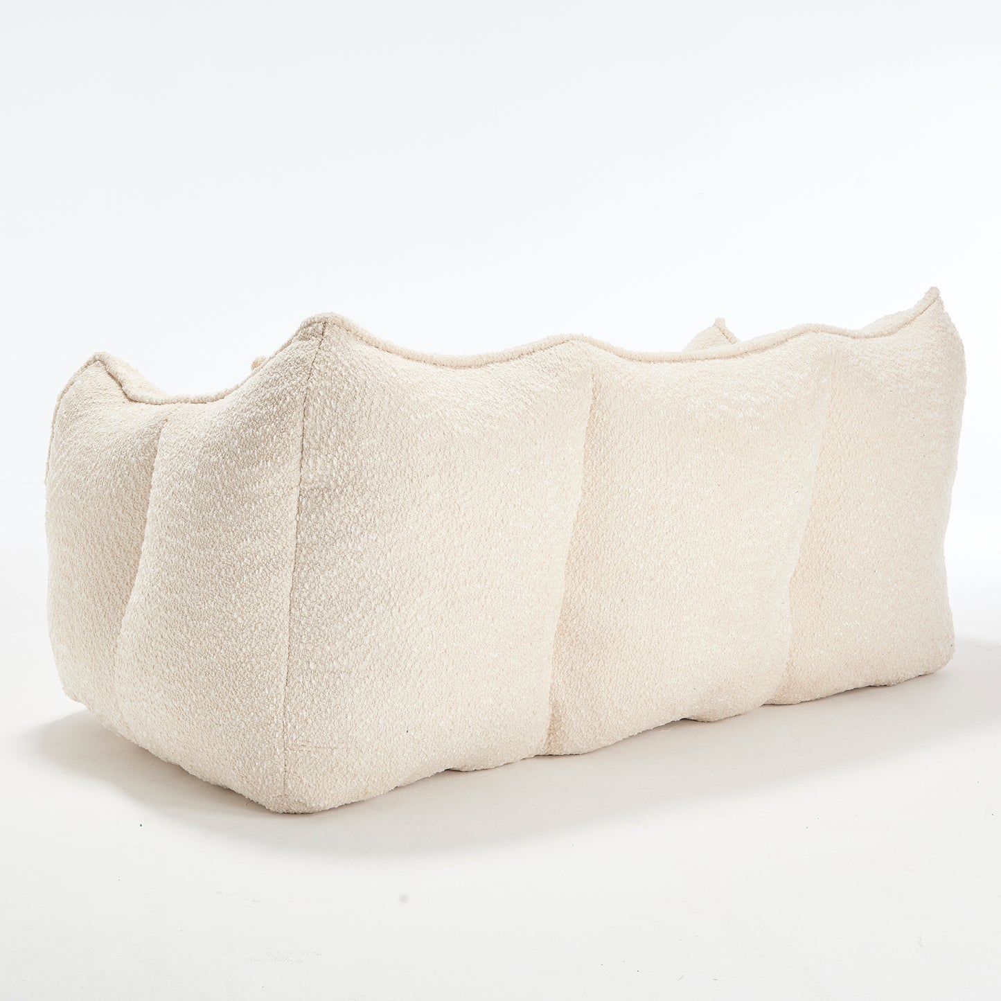 Cream boucle fabric sectional sofa with a curved organic design ideal for modern living rooms
