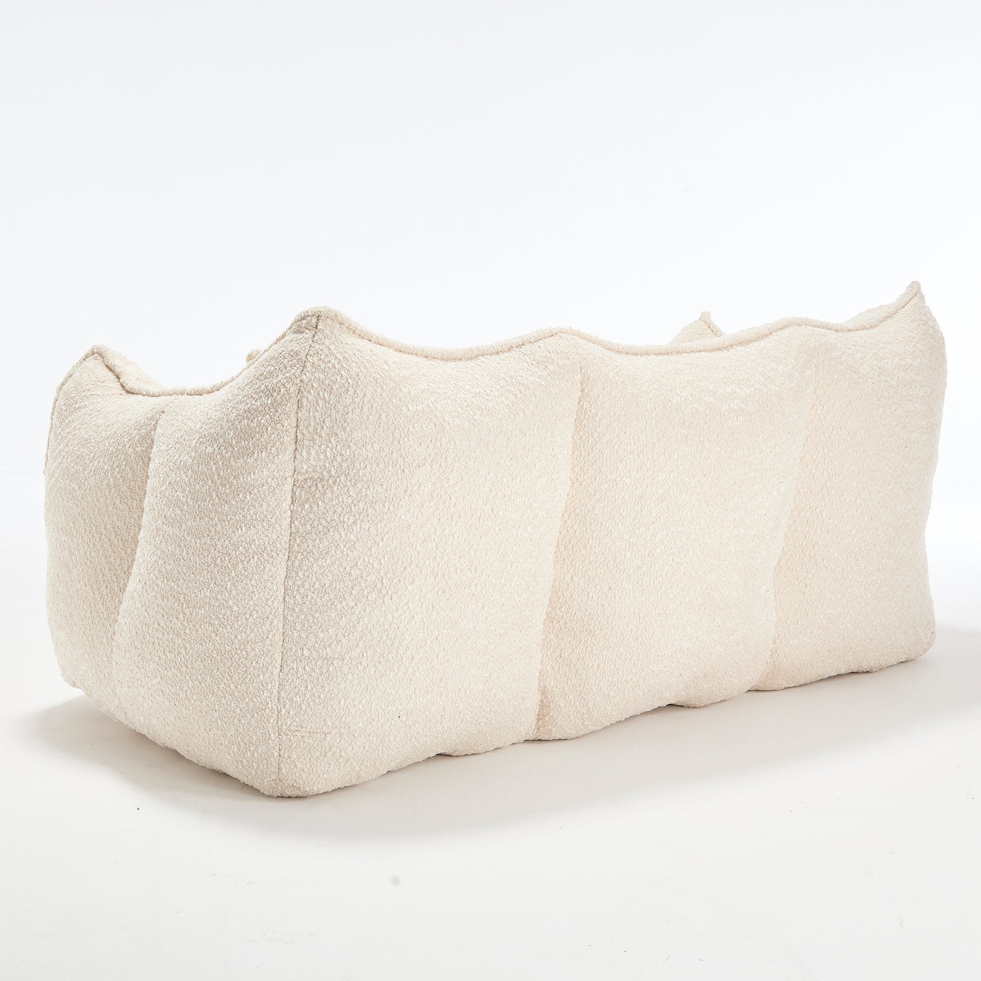 Cream boucle fabric sectional sofa with a curved organic design ideal for modern living rooms