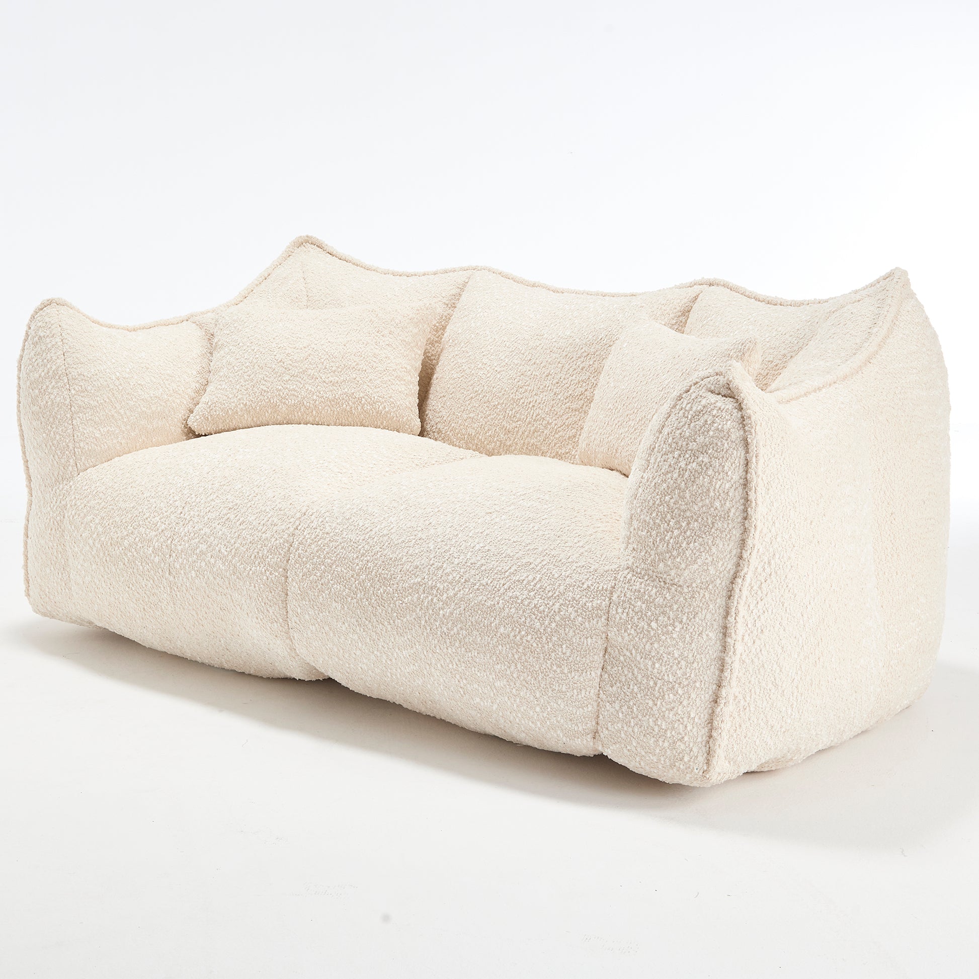 Plush cream boucle fabric sofa with rounded arms and back featuring accent pillows for comfort and style