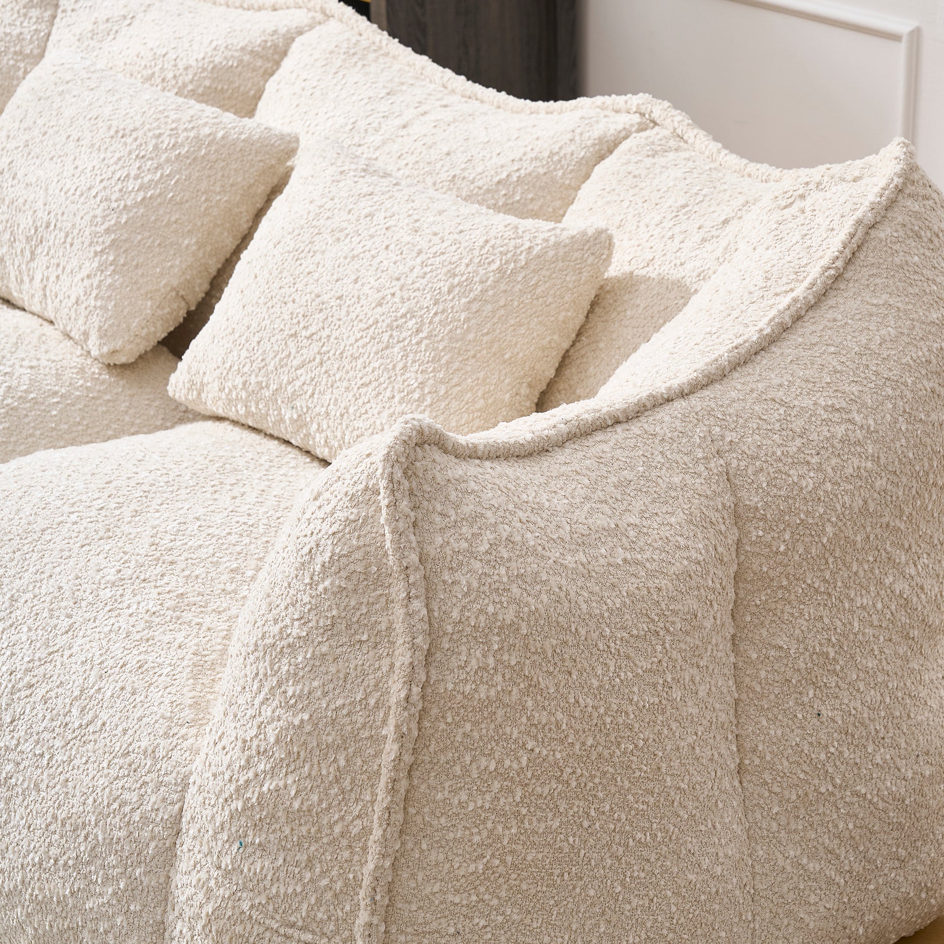 Cream boucle fabric sofa with plush cushions for ultimate comfort and modern living