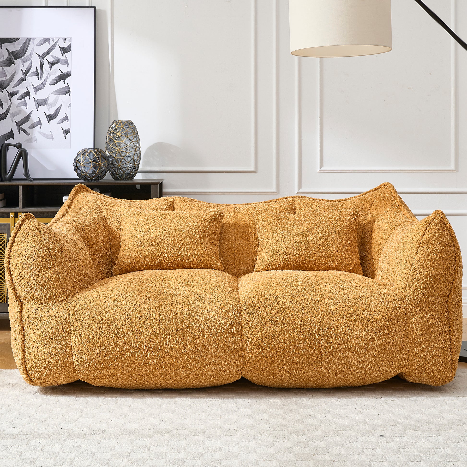 Plush mustard yellow boucle fabric sofa with two matching throw pillows for comfortable seating