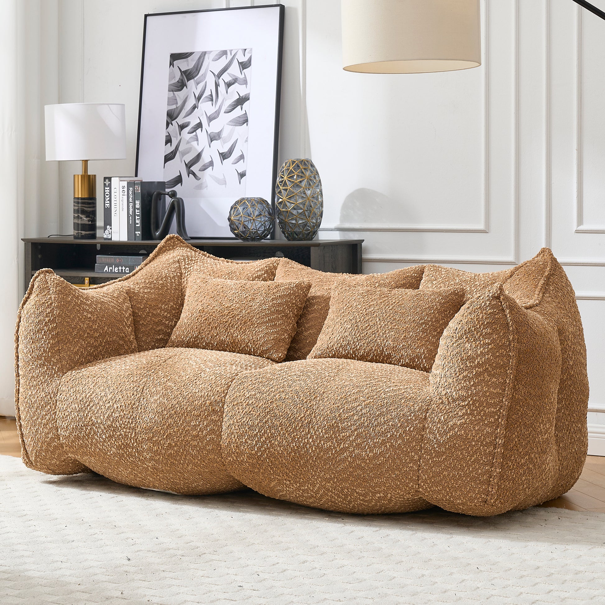 Textured boucle fabric sofa in a warm camel color featuring plush cushions and a modern organic design for living rooms