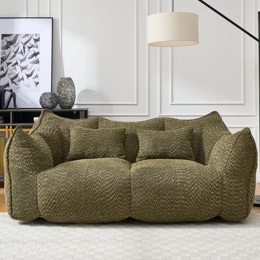 Textured green fabric couch with two accent pillows perfect for a modern living room