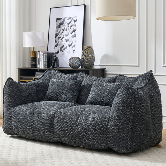 Plush charcoal boucl sofa with deep seating and oversized throw pillows for ultimate comfort