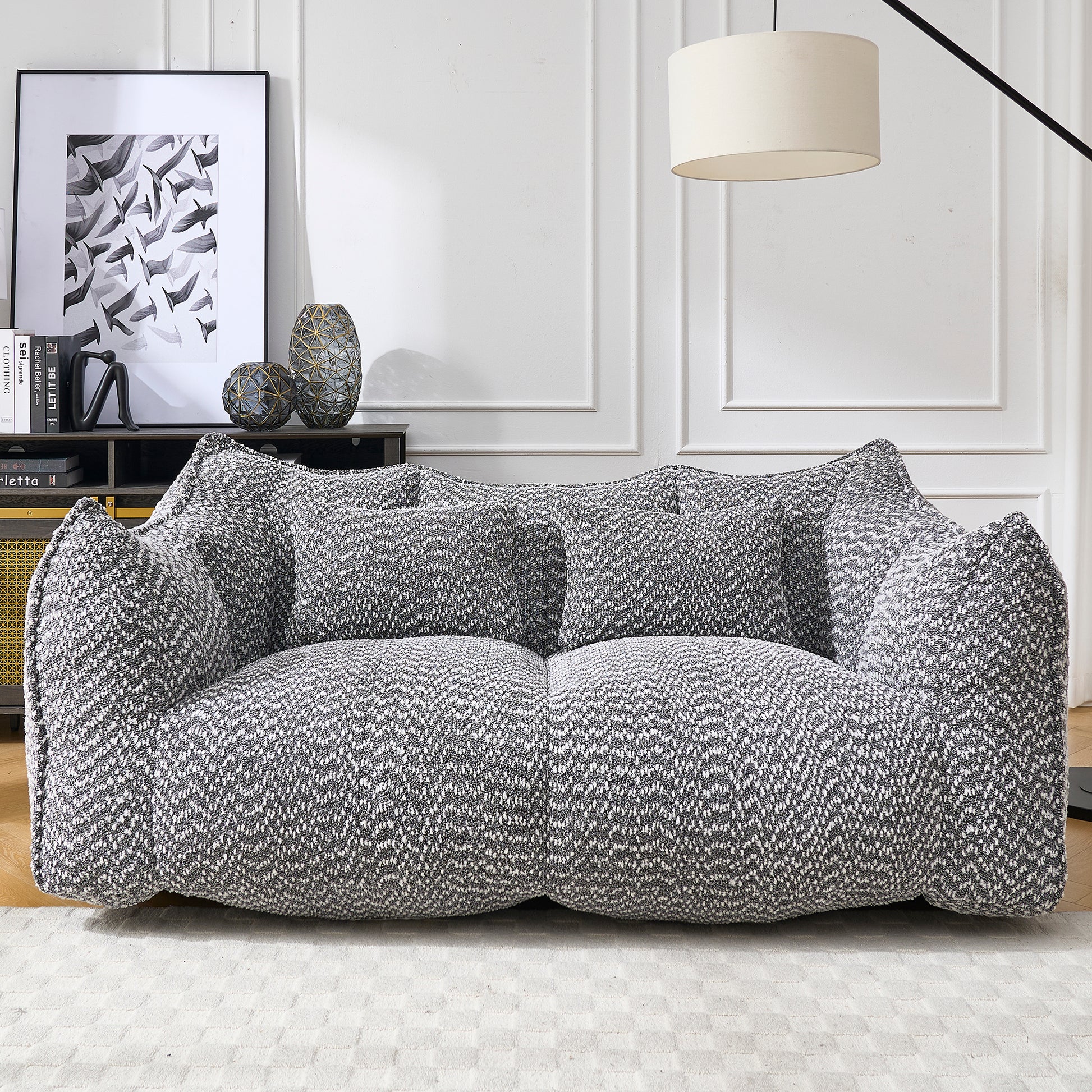 Plush grey and white boucl sofa with deep seating and multiple cushions for ultimate comfort