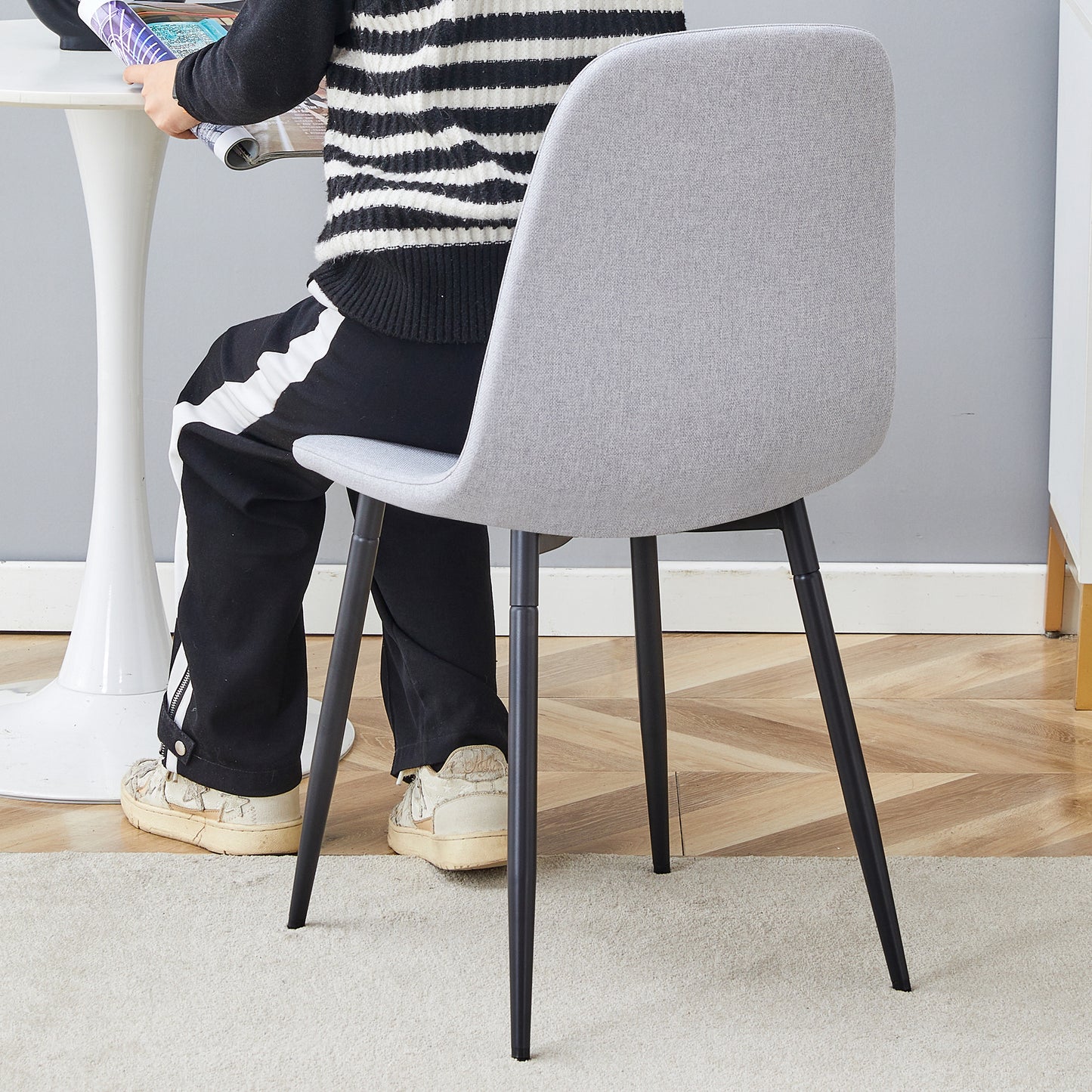Modern light gray fabric accent chair with slim black metal legs