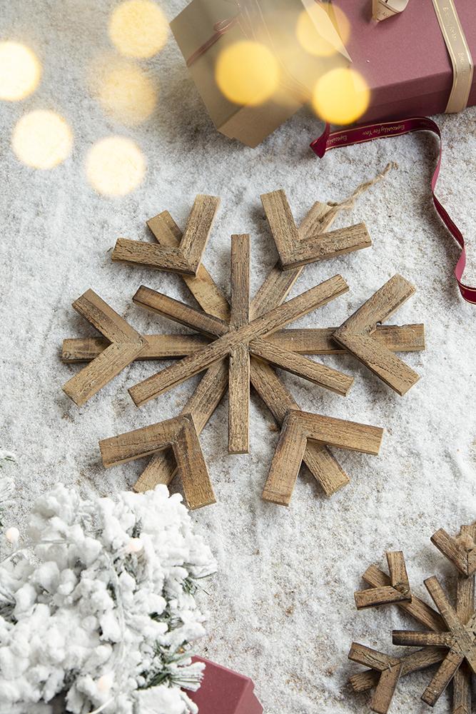 Rustic wooden snowflake Christmas ornament with weathered texture and six pointed design