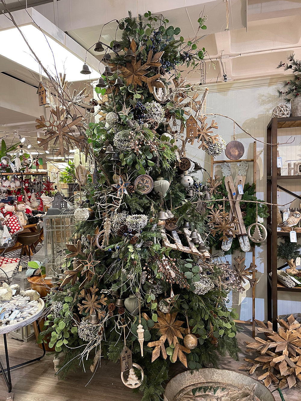 Rustic Christmas tree adorned with wood snowflakes bells and natural elements