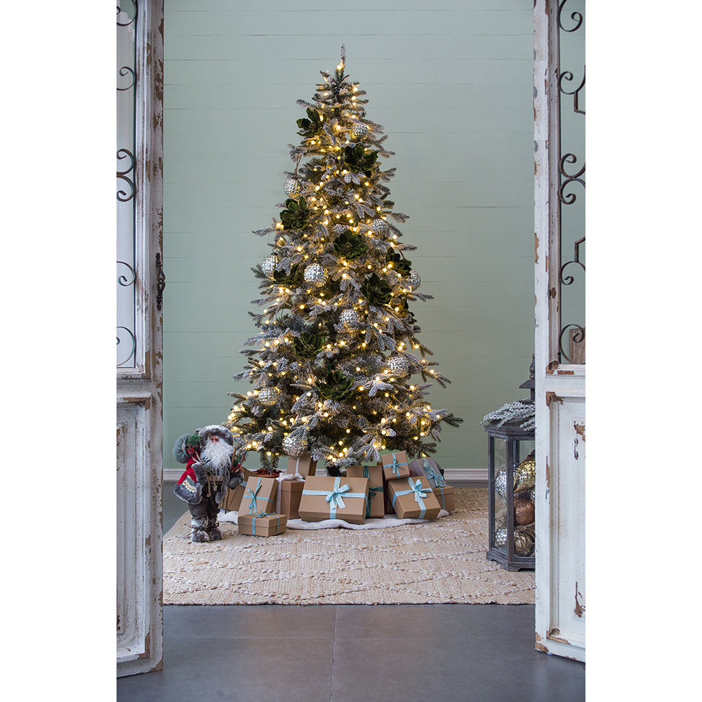 Flocked Christmas tree with warm LED lights and green succulent ornaments ready for holiday gifting