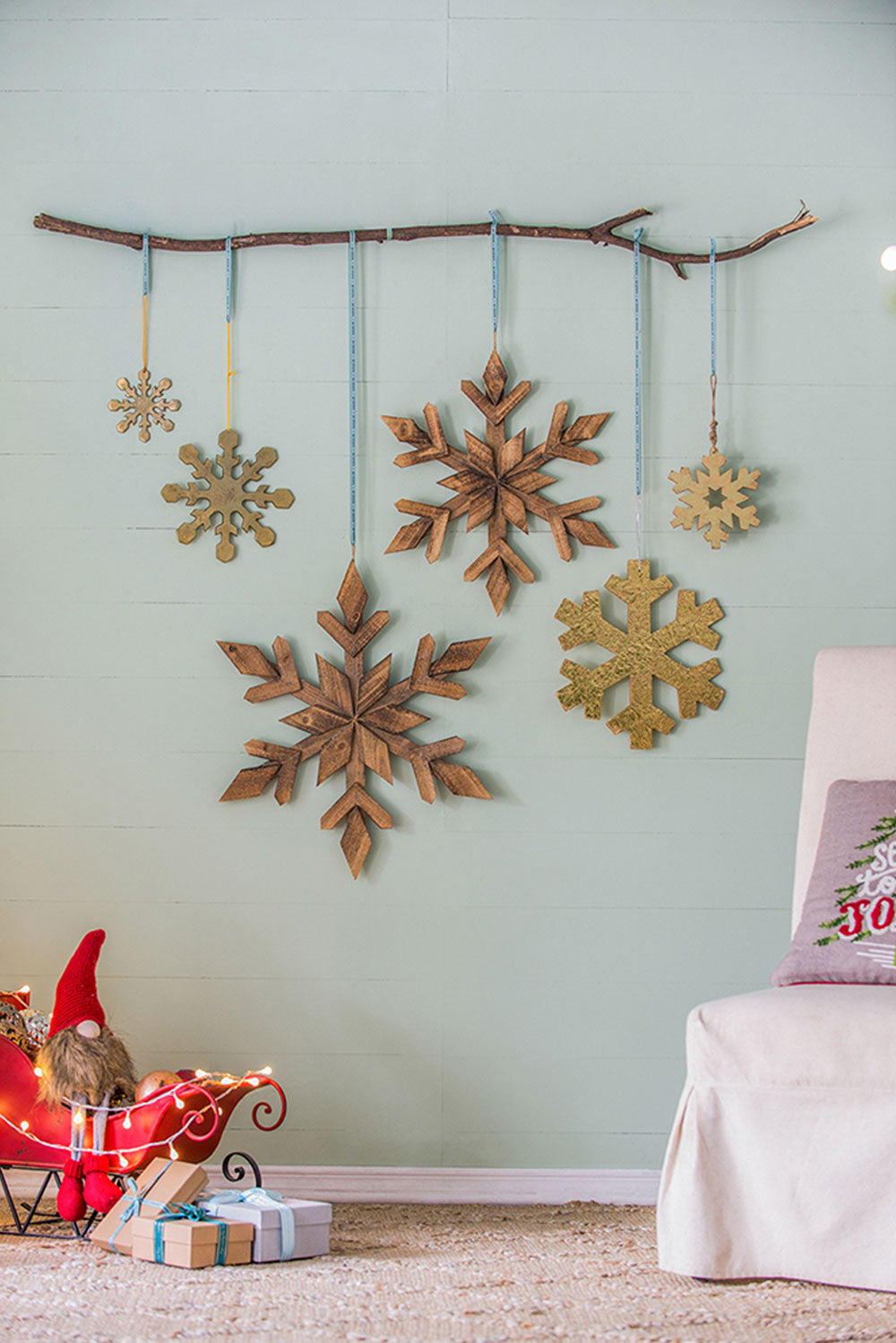 Rustic wooden snowflake Christmas ornaments hanging on a branch