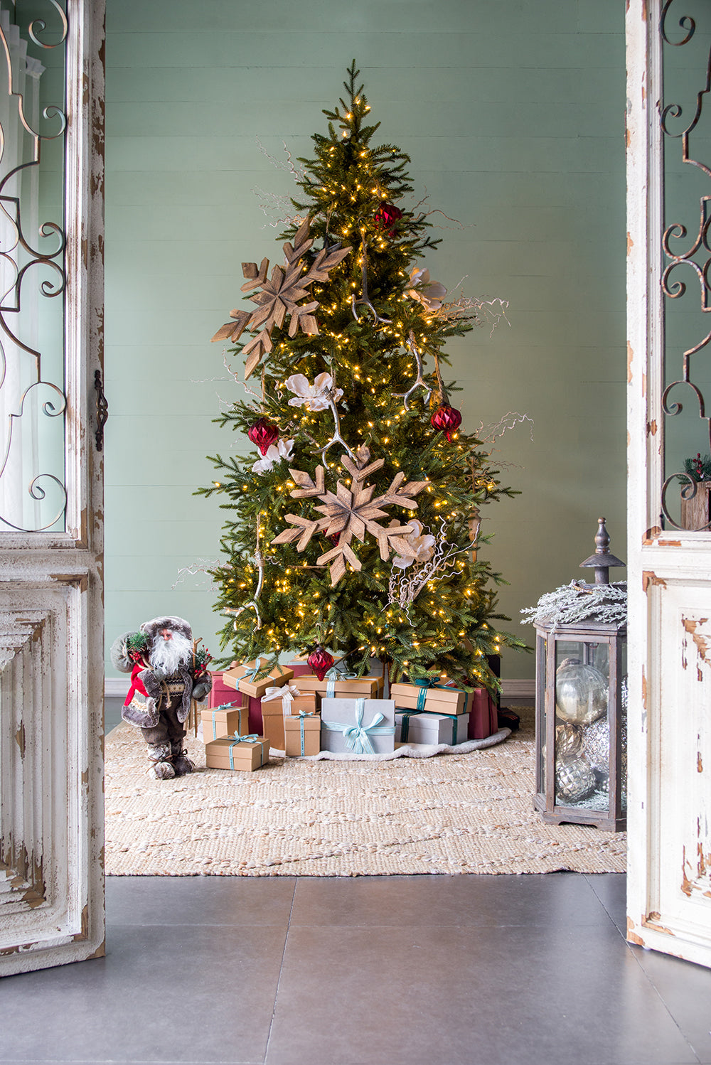 Decorated Christmas tree with warm lights and wooden snowflake ornaments