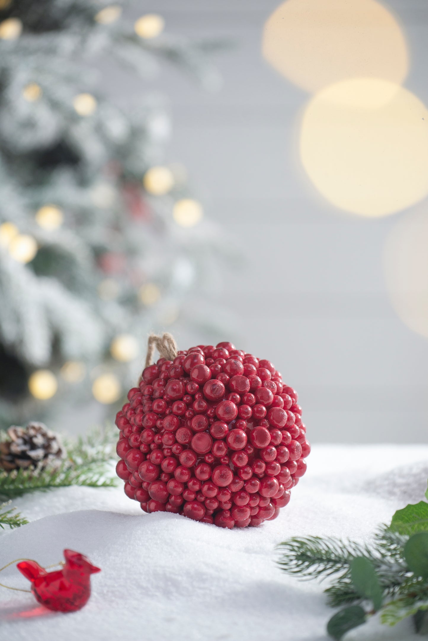 Textured red berry candle with twine hanger ideal for festive home decor