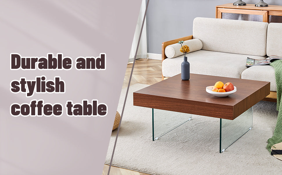 Dark wood coffee table with glass legs featuring a fruit bowl and vase