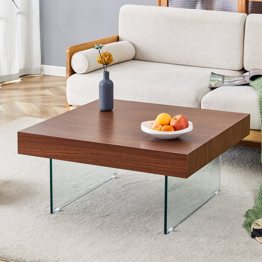 Modern square walnut coffee table with clear glass legs perfect for living rooms