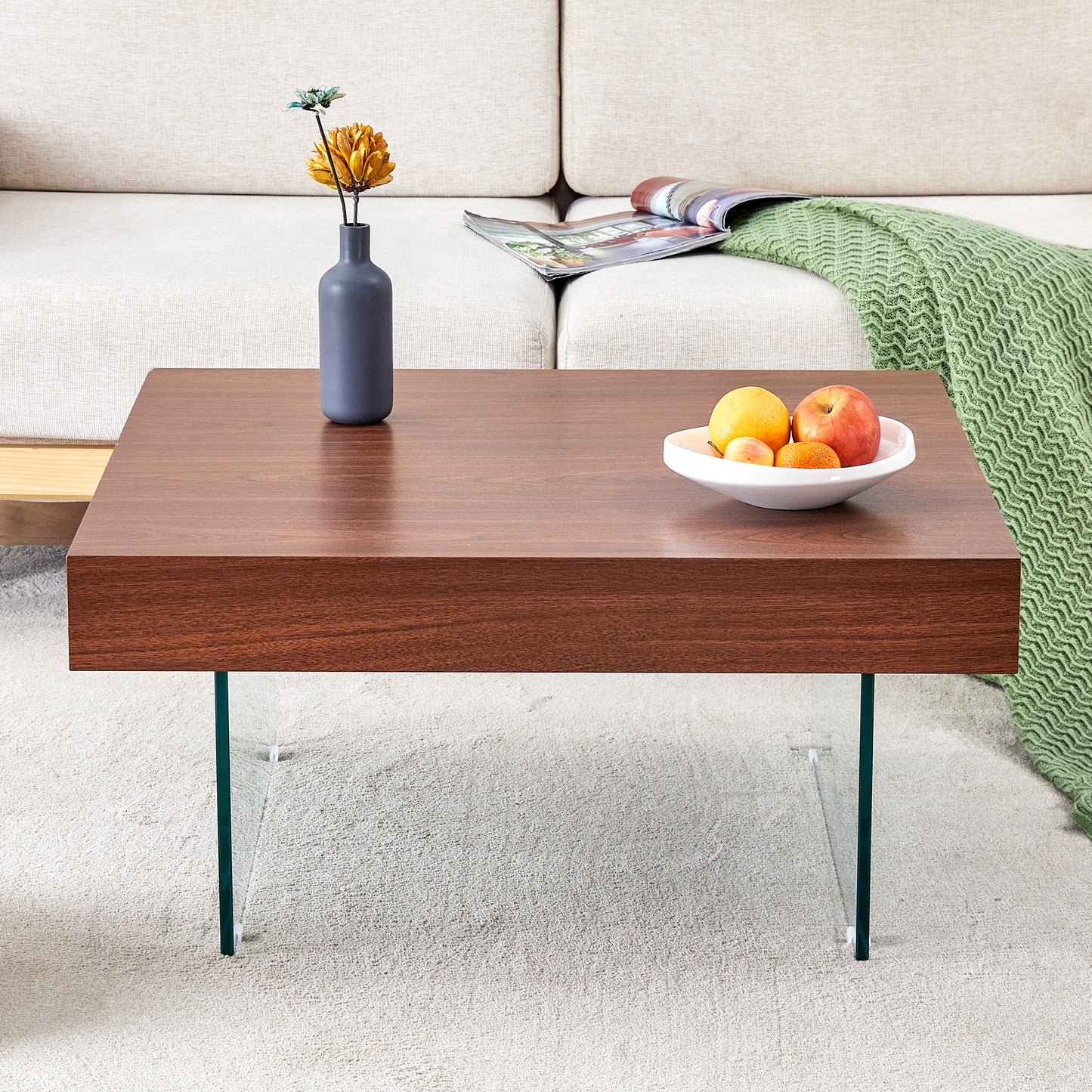 Rich walnut veneer coffee table with clear glass legs and a modern minimalist design