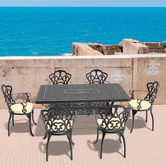 Ornate black cast aluminum patio dining set with cream cushions