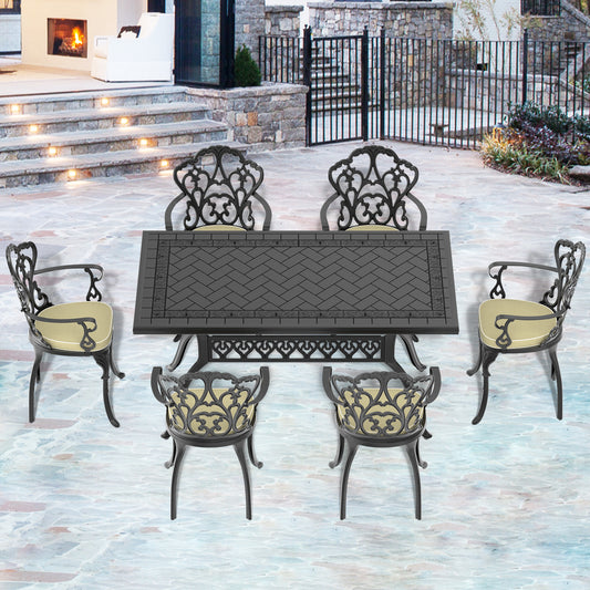 Ornate cast iron patio dining set with black metal table and upholstered chairs