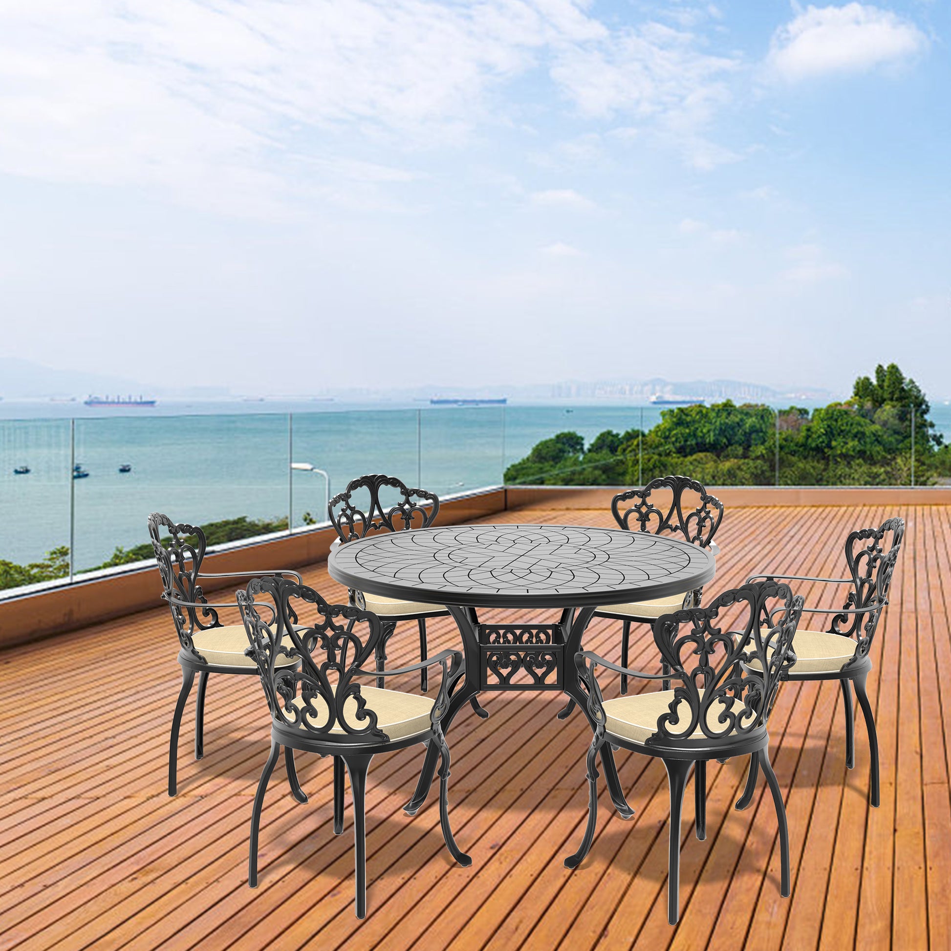 Black cast iron patio dining set with ornate chairs and round table