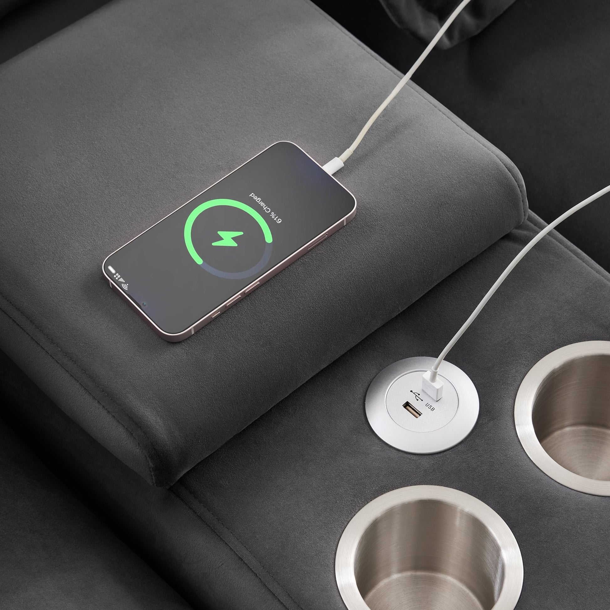 Dark grey recliner with integrated USB charger port and phone charging showcasing modern convenience