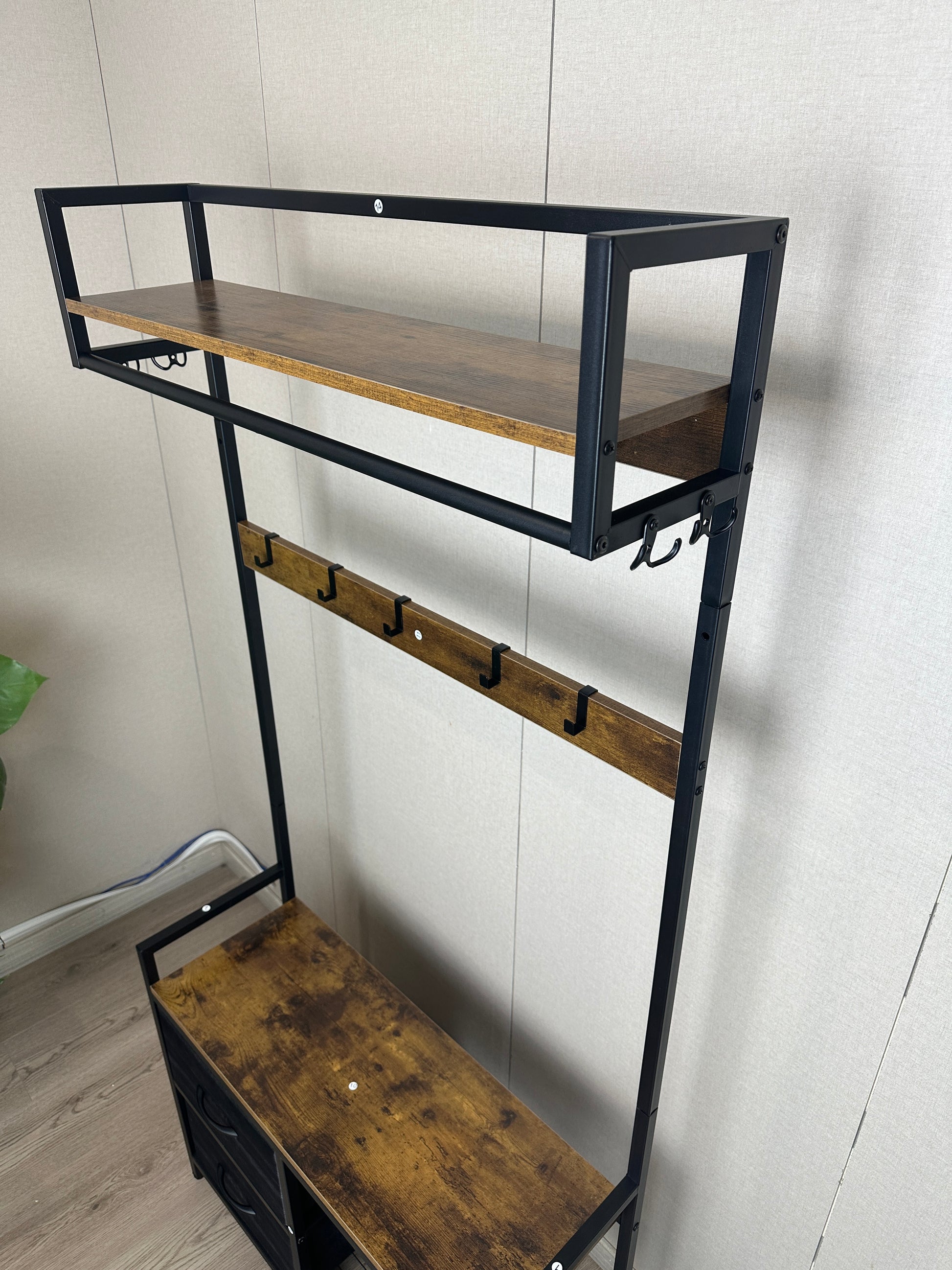 Industrial entryway hall tree with black metal frame and rustic wood shelves for coats