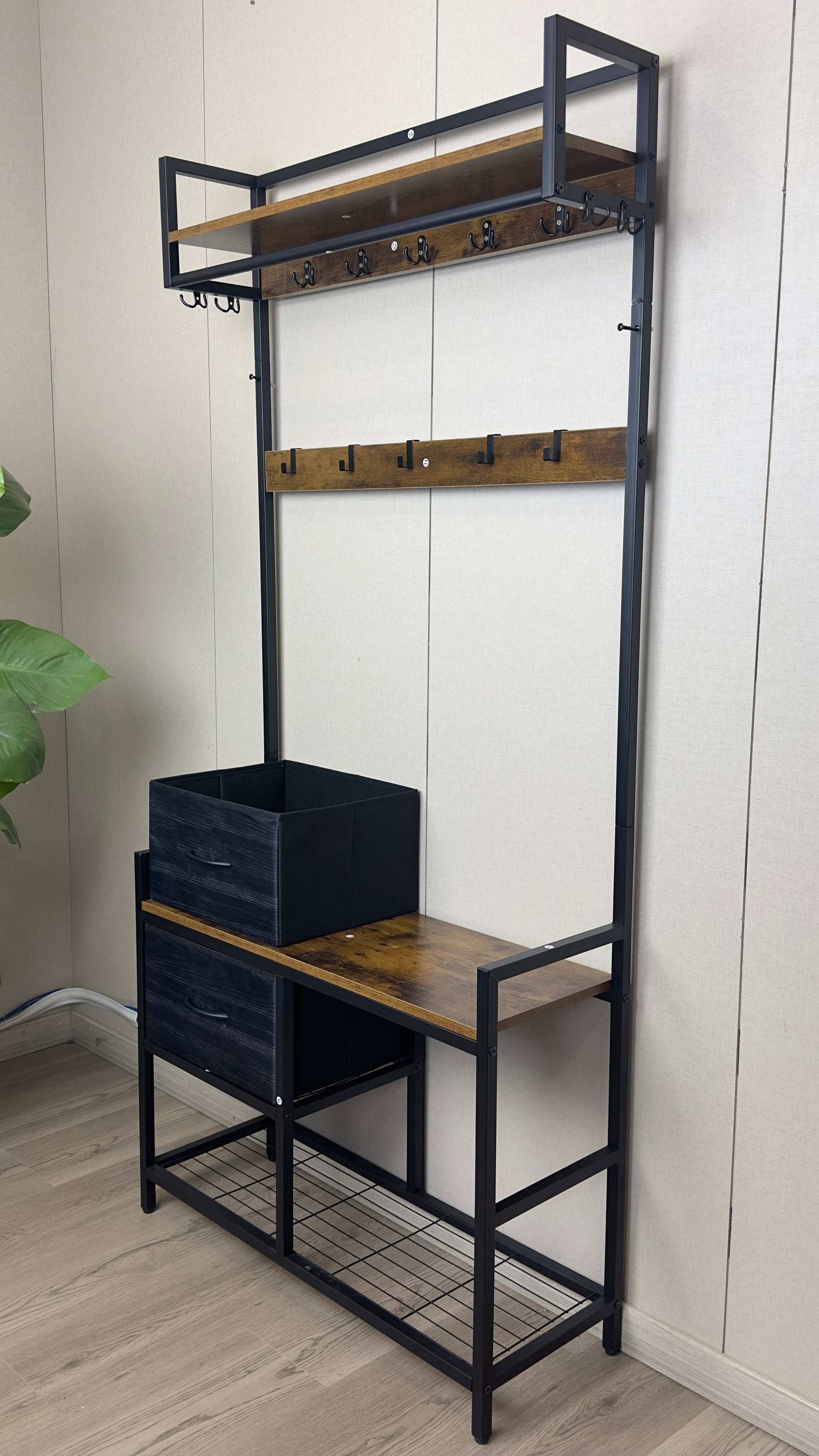 Rustic wood and black metal hall tree with coat hooks and storage shelves