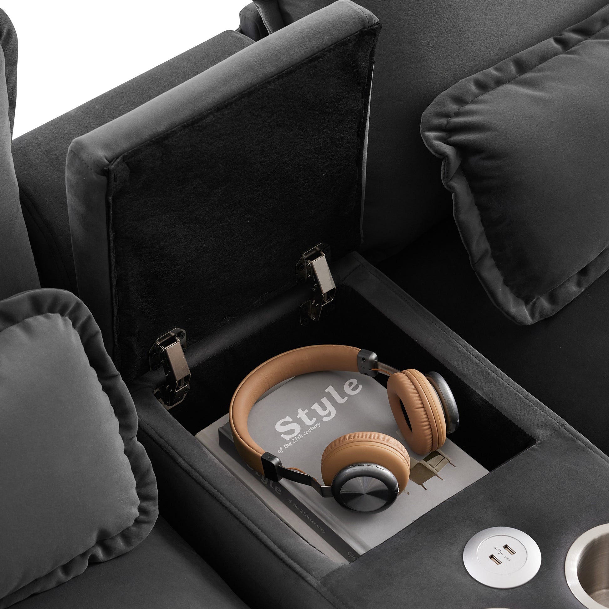 Dark grey velvet recliner with hidden storage compartment featuring headphones and a book