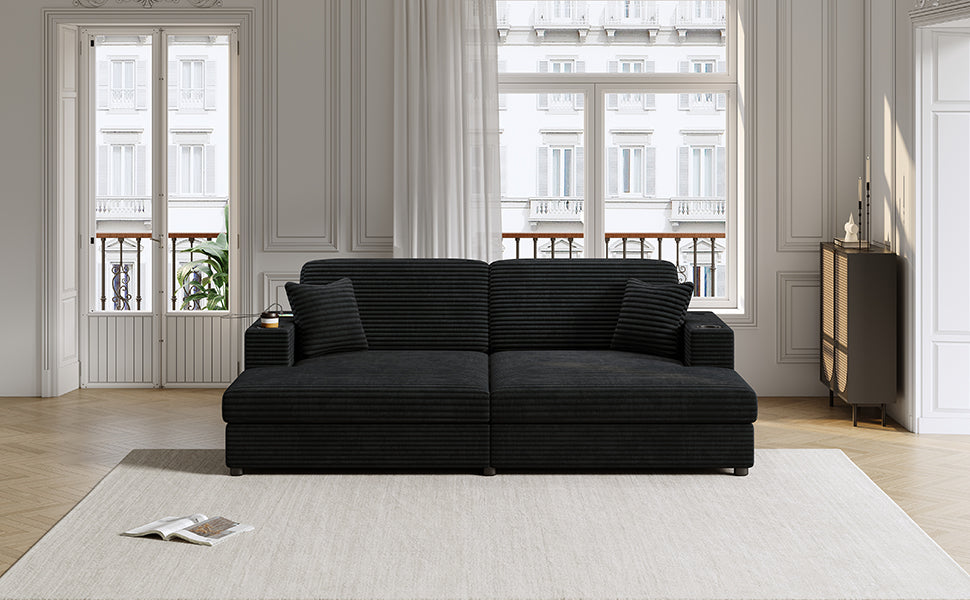 Black corduroy sectional sofa with plush pillows and integrated cup holders