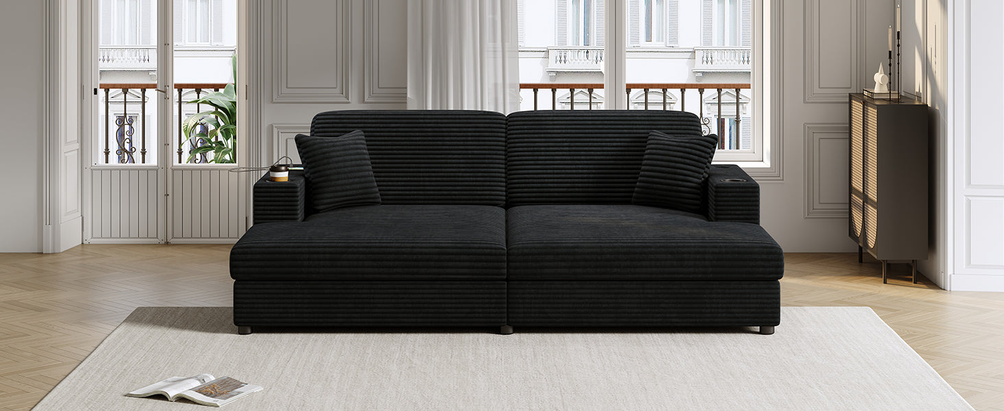 Black corduroy sectional sofa with integrated cup holders and throw pillows