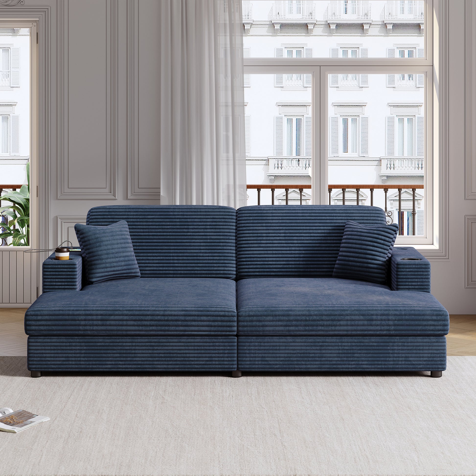 Deep blue corduroy sectional sofa with two throw pillows and builtin cup holders