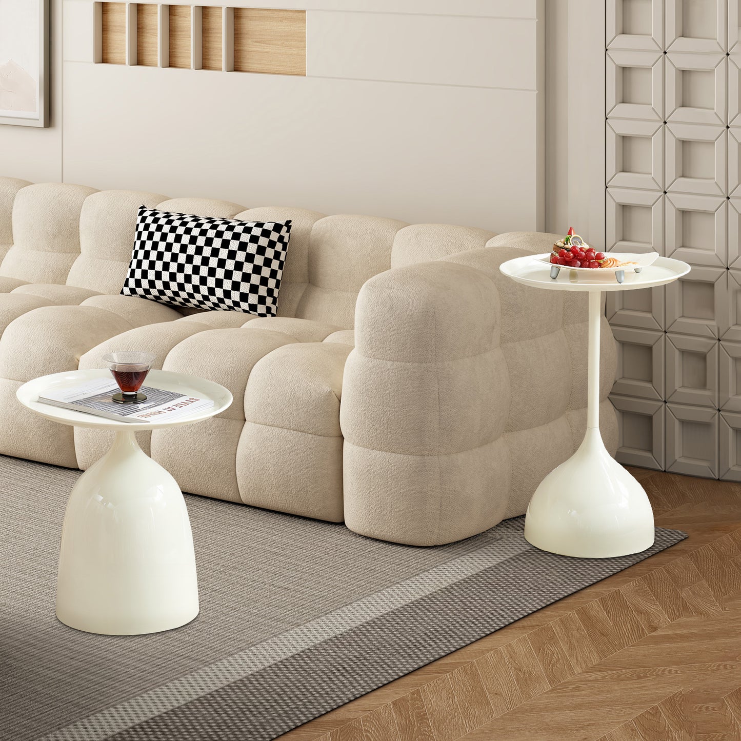 Modern white tulip side table with round tray top next to a sofa