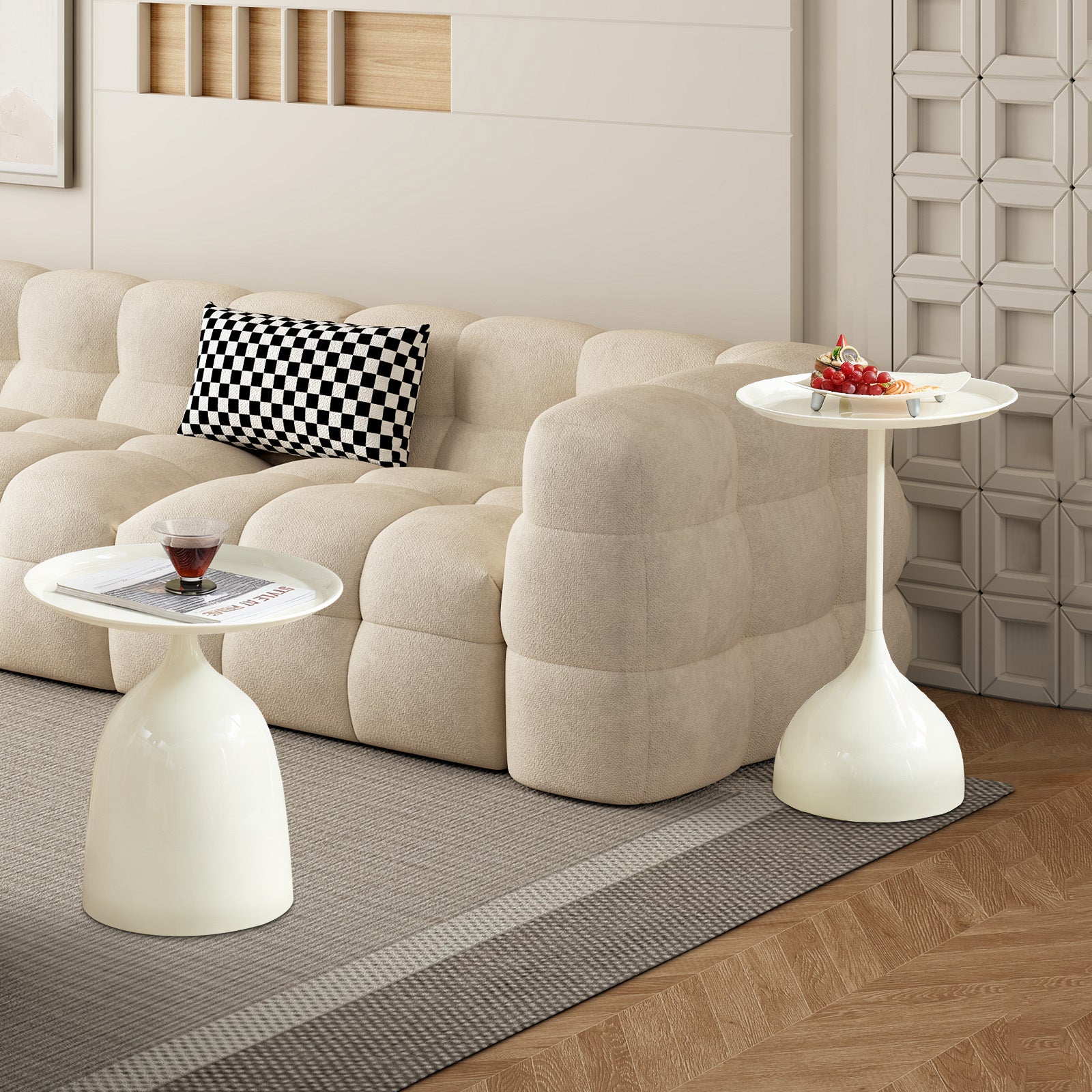 Modern white tulip side table with round tray top next to a sofa