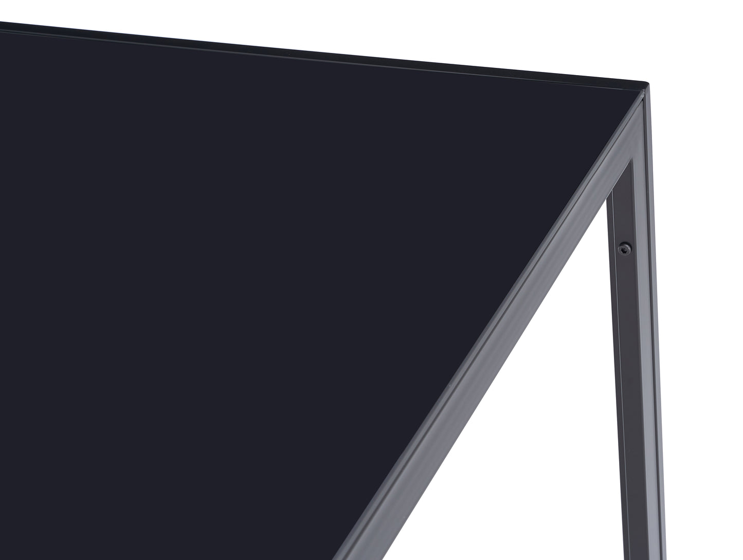 Closeup of a dark grey metal frame supporting a black glass table top