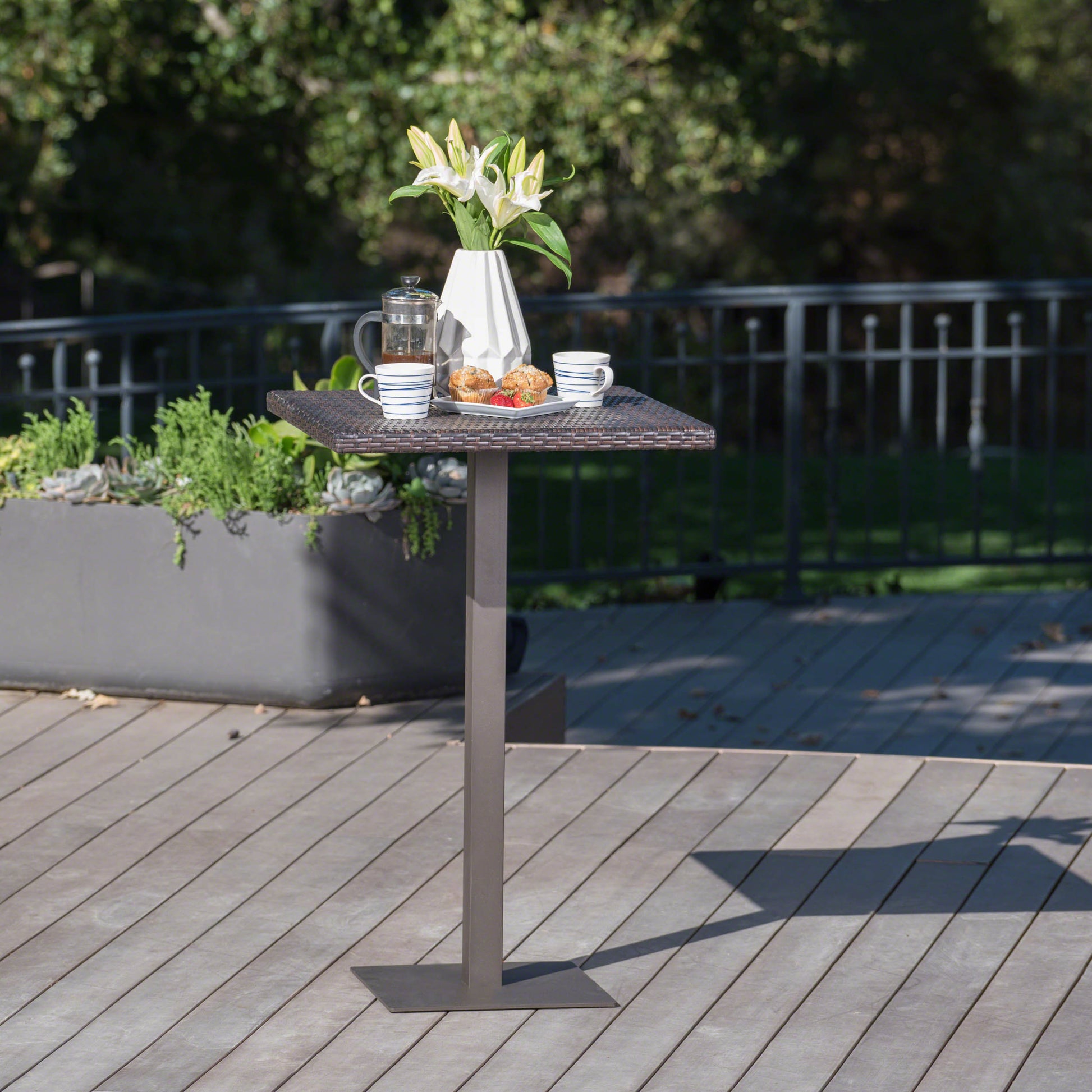 Brown wicker outdoor bar table with square metal base