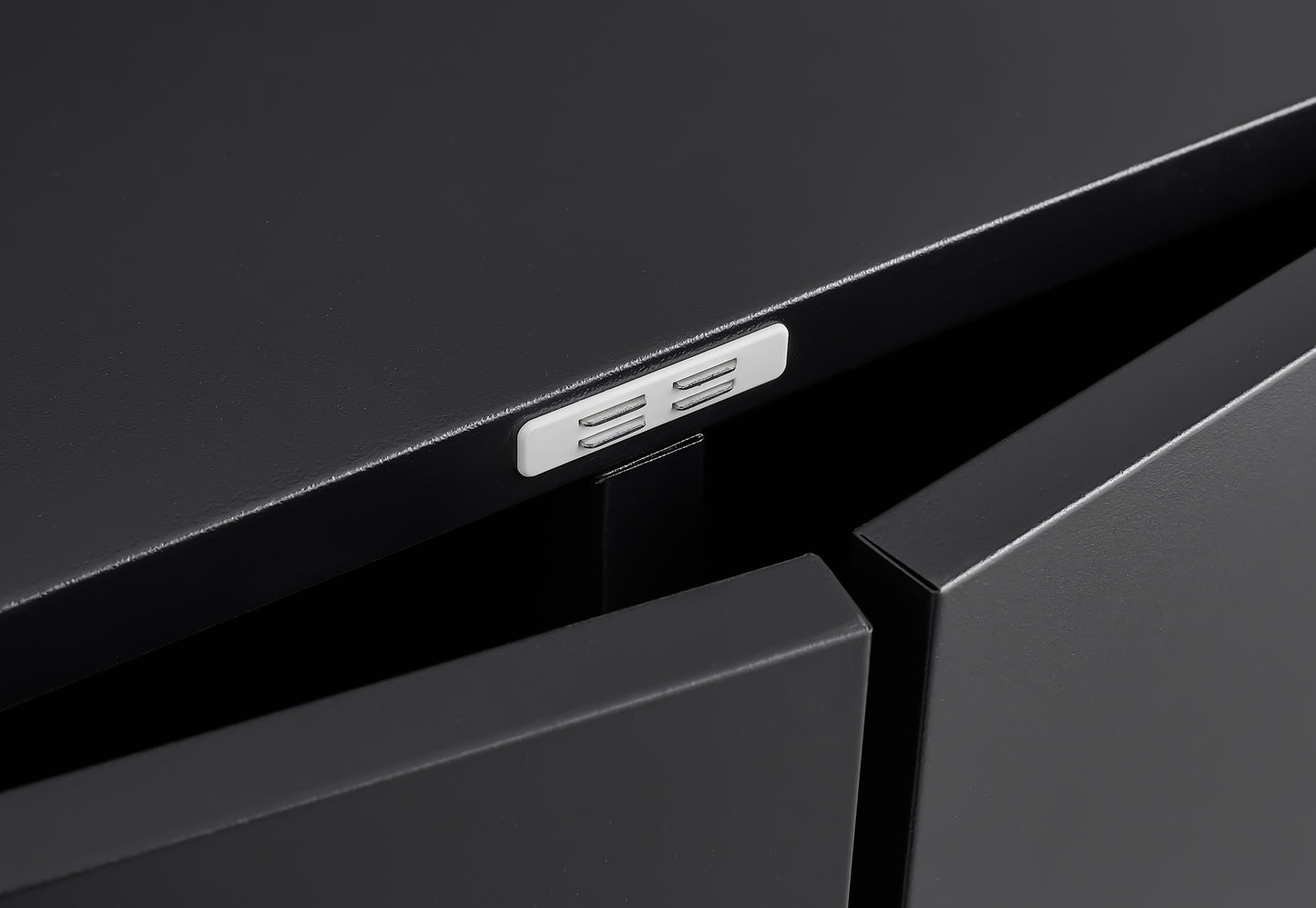 Closeup of black matte cabinet doors with integrated pushtoopen latch mechanism
