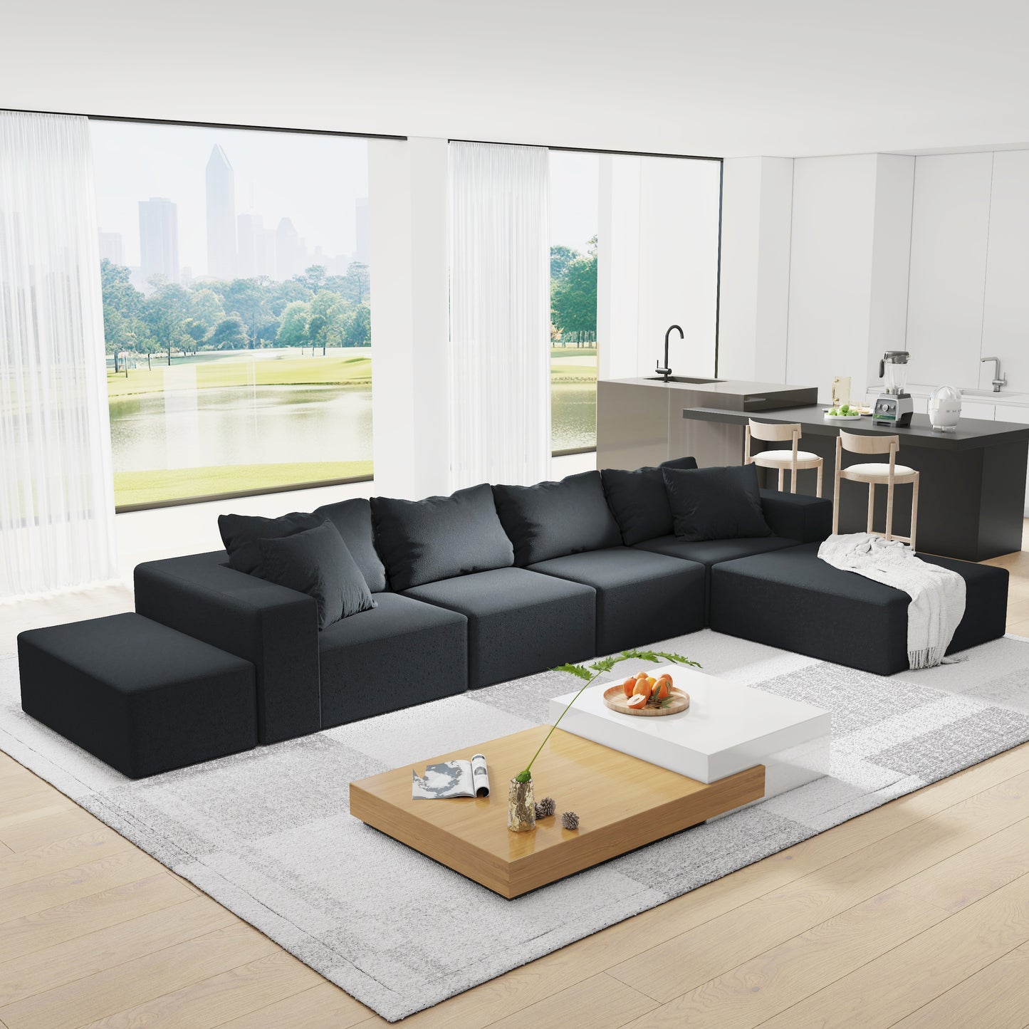 Dark gray sectional sofa with plush cushions and an ottoman on a modern rug perfect for living rooms