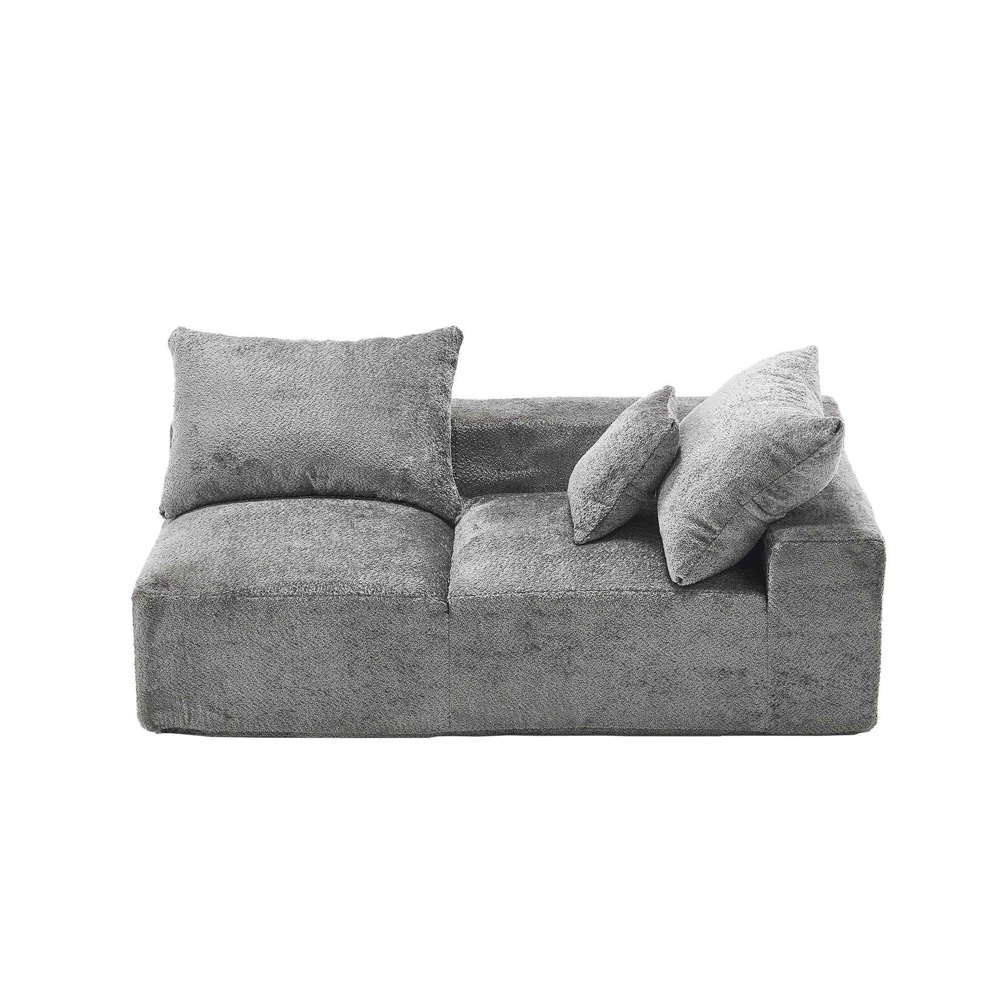 Plush grey fabric sofa with textured upholstery and three throw pillows for modern living room comfort