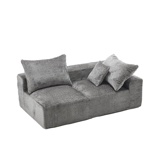 Plush grey twoseater sofa with textured fabric and three scatter cushions perfect for a modern living room