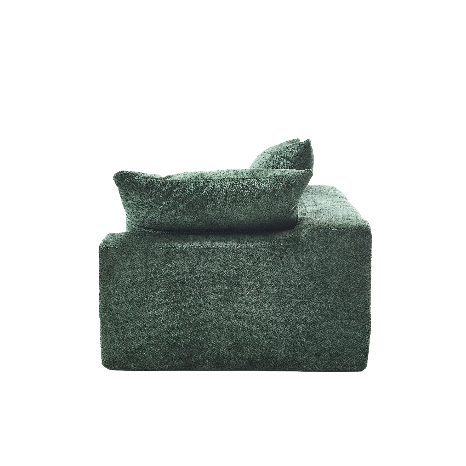 Plush green textured armchair with deep seat and soft cushions