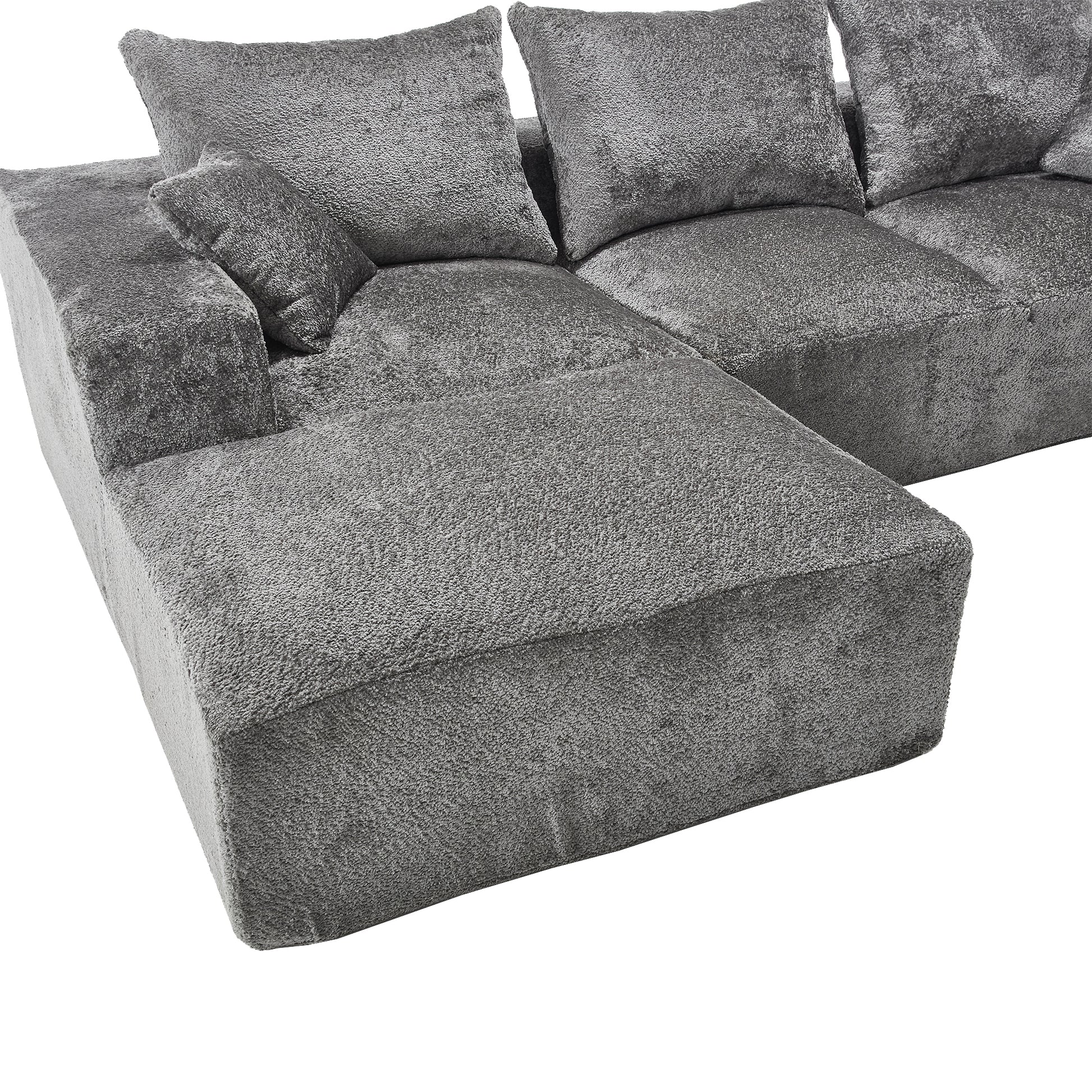 Plush grey modular sofa with deep seats and matching throw pillows