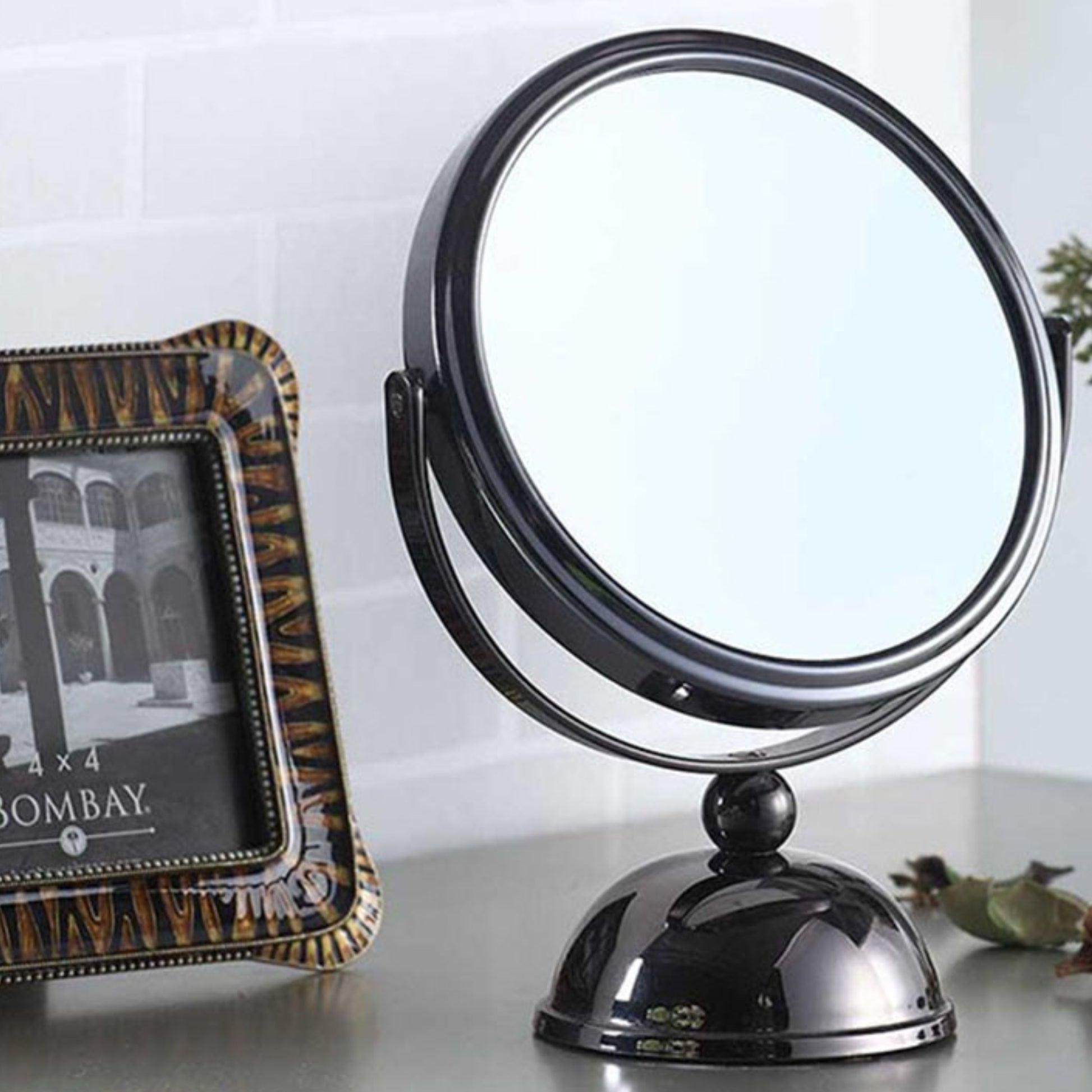 Black metal tabletop vanity mirror with adjustable arm and domed base