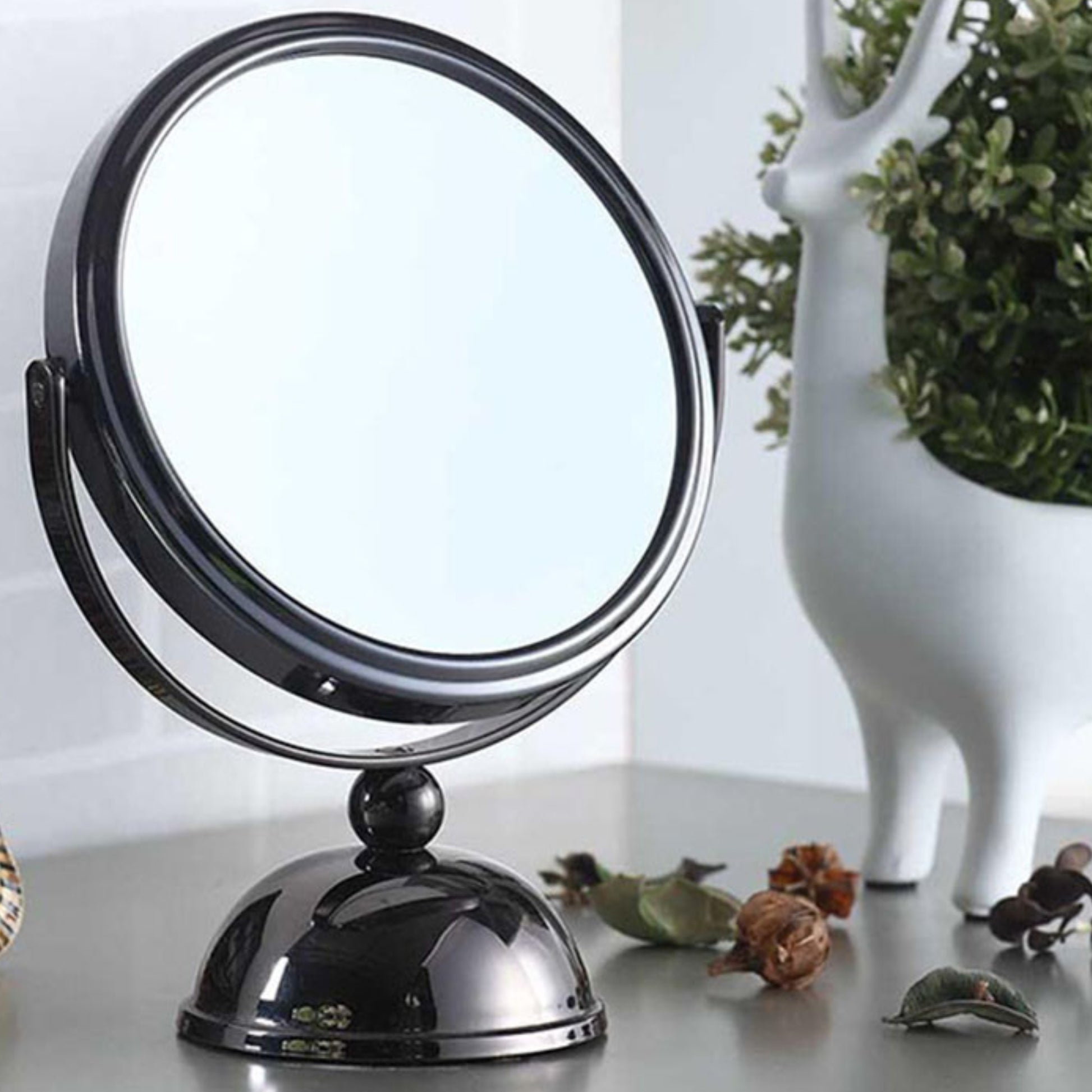 Modern black metal vanity mirror with adjustable swivel arm and weighted base for makeup application