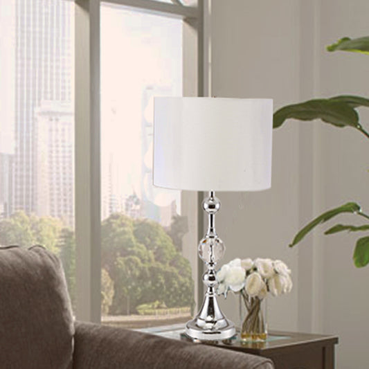Contemporary silver table lamp with crystal accents and a white drum shade