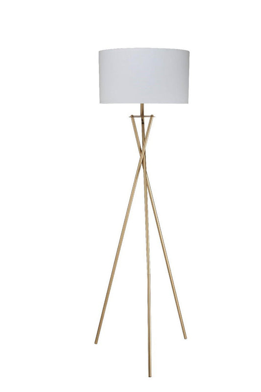 Modern gold tripod floor lamp with white drum shade provides ambient lighting