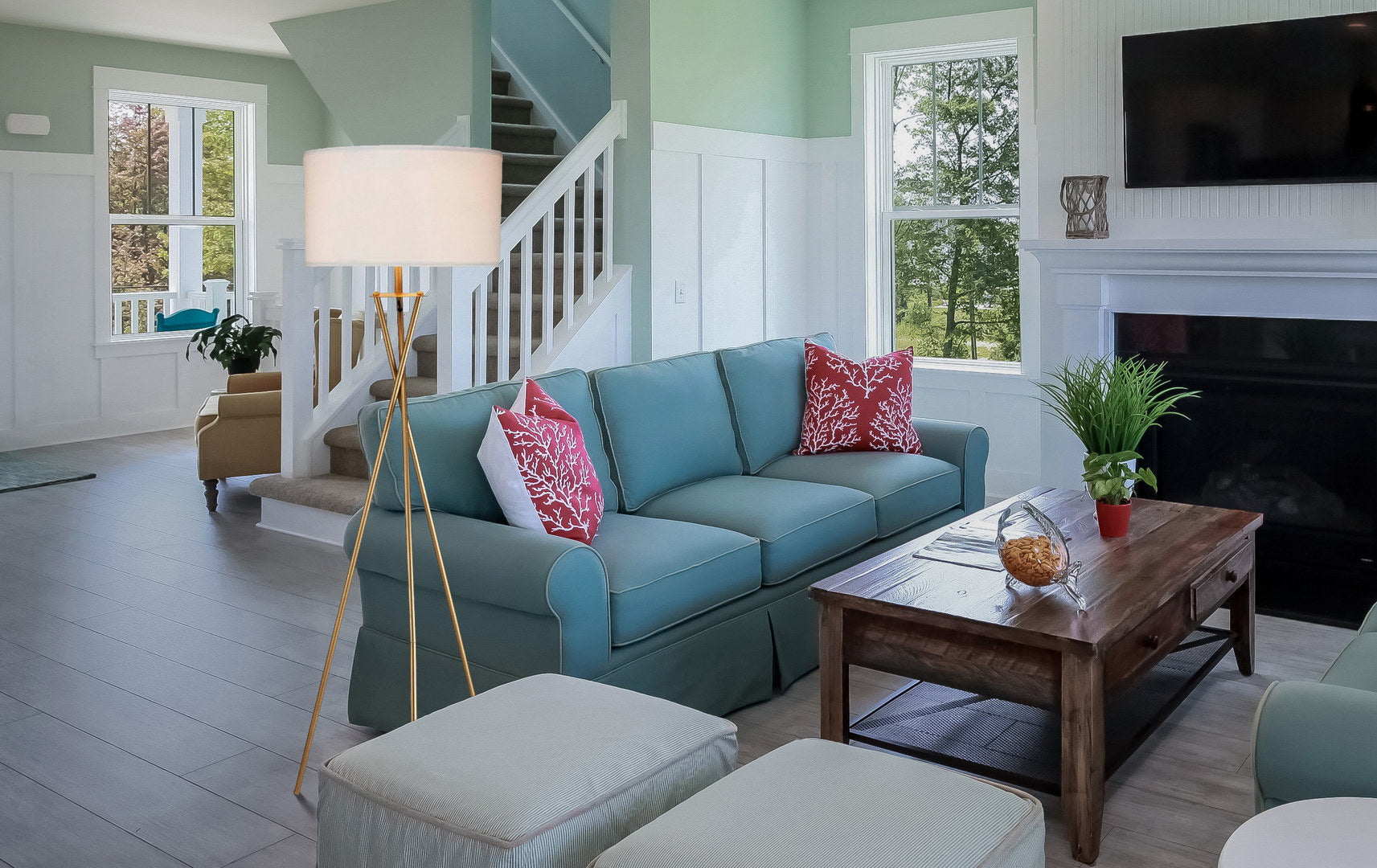 Aqua blue linen seater sofa with coral print throw pillows for living room comfort